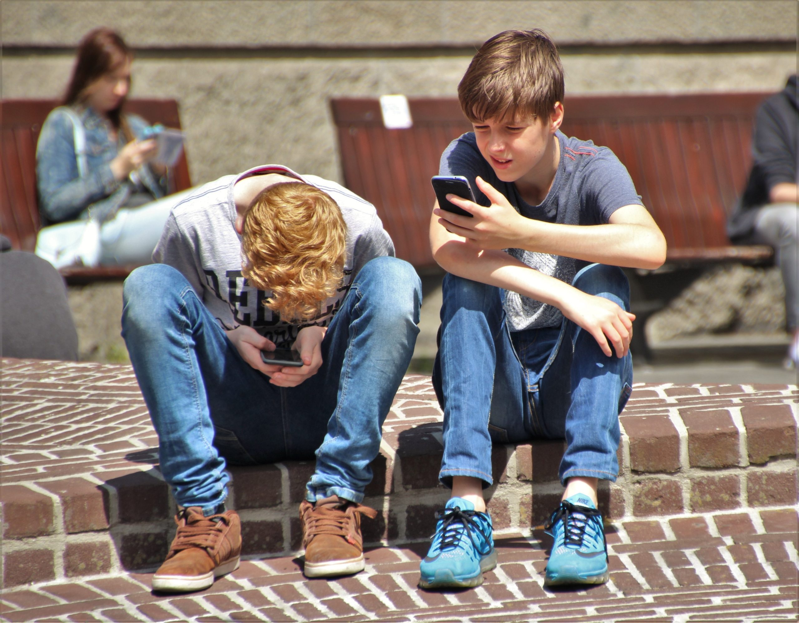 Teen boys on their phones